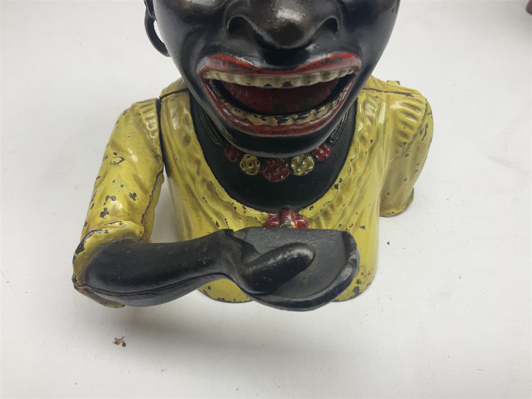 Three early 20th century cast-iron mechanical money banks as a