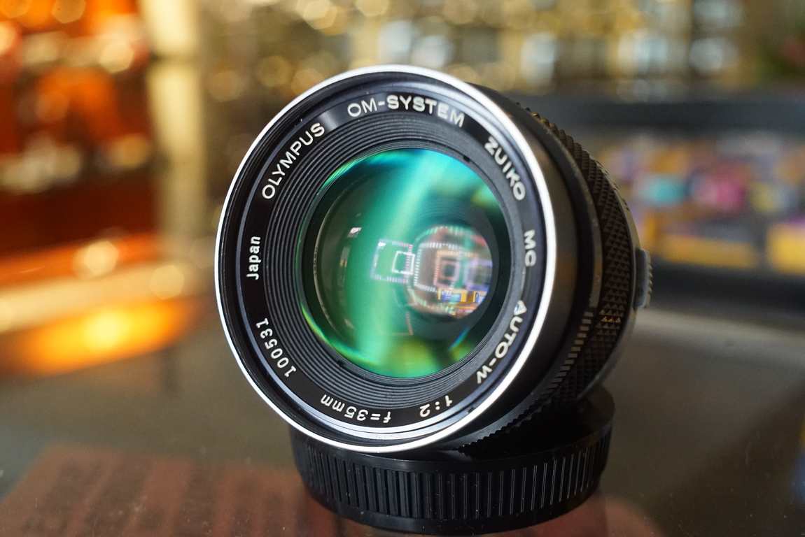 Olympus OM Zuiko 35mm f/2 Chrome nose MC + hood - Fotohandel