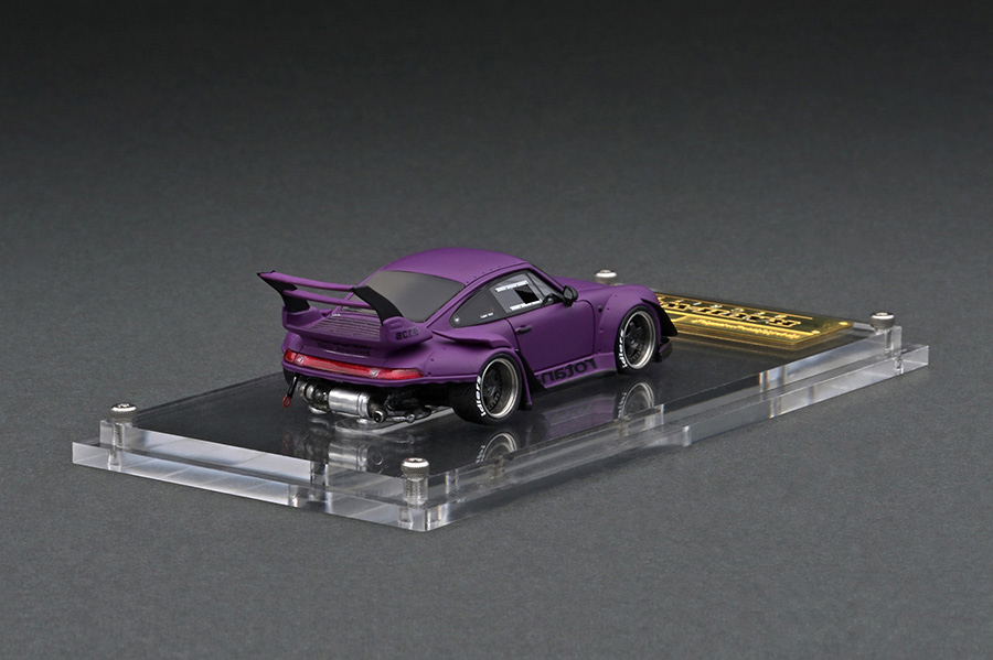 IG2363 1/64 RWB 993 Matte Purple With Mr. Nakai sitting on sofa